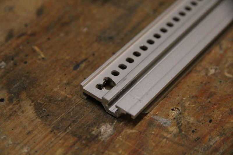 Rail from top side of the modular suitcase with hole drilled through for fixing with screw